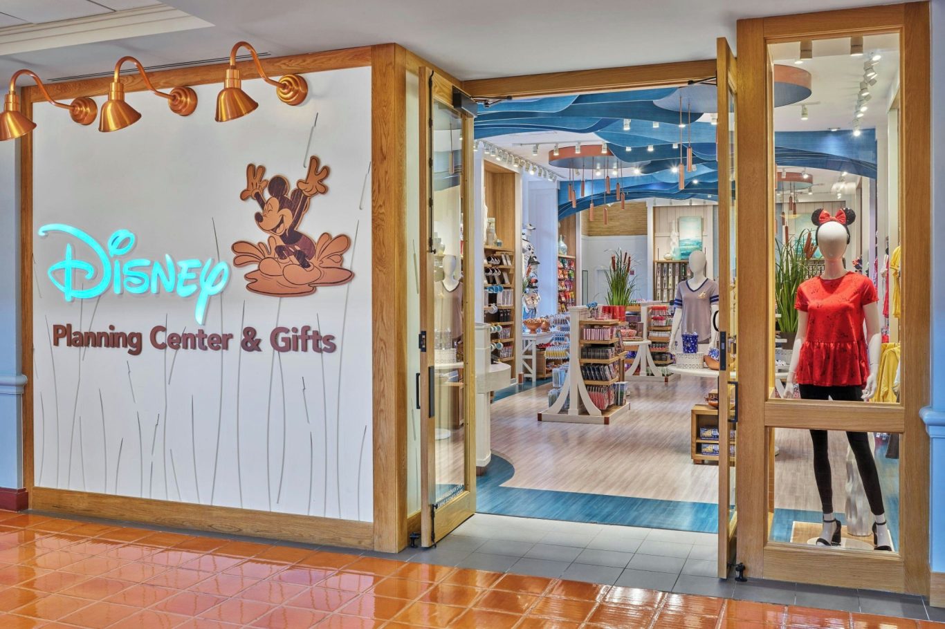 Disney planning centre and gifts store entrance with a mannequin in red near the door.