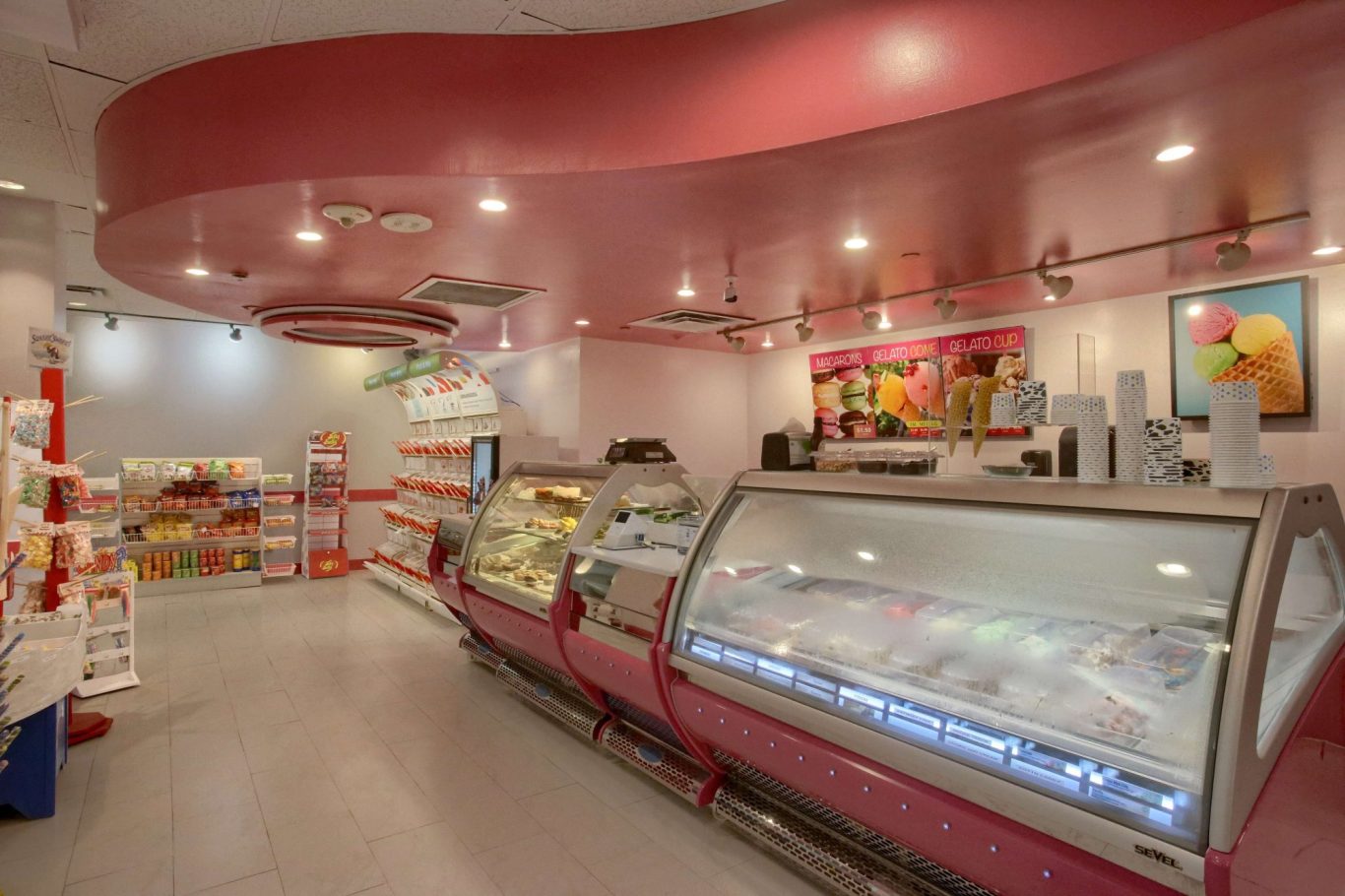 Ice cream shop interior with pink accents and display freezers.