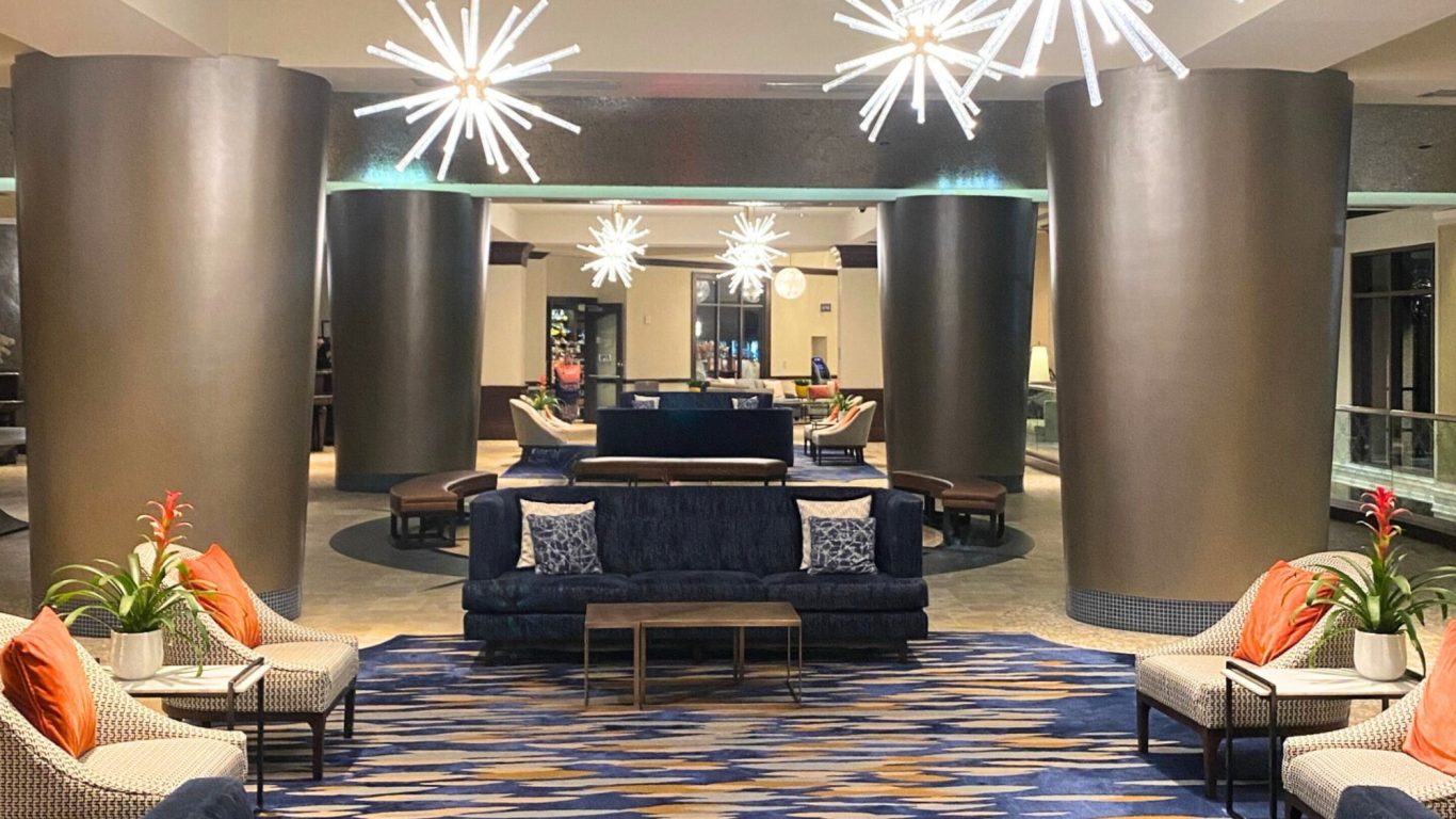 Modern hotel lobby with stylish seating and decorative lighting.