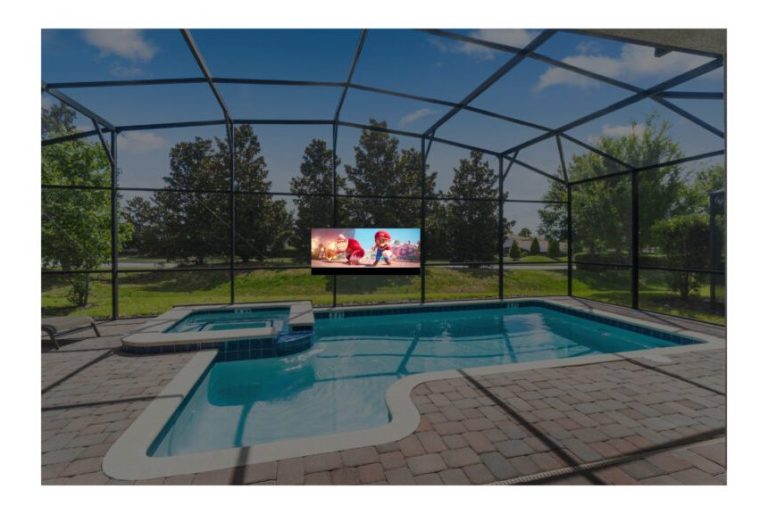 Swimming pool with a spa and outdoor TV, surrounded by greenery and a screened enclosure.