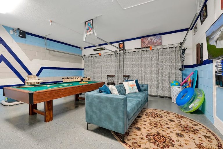 A game room featuring a pool table, sofa, and colourful decor.