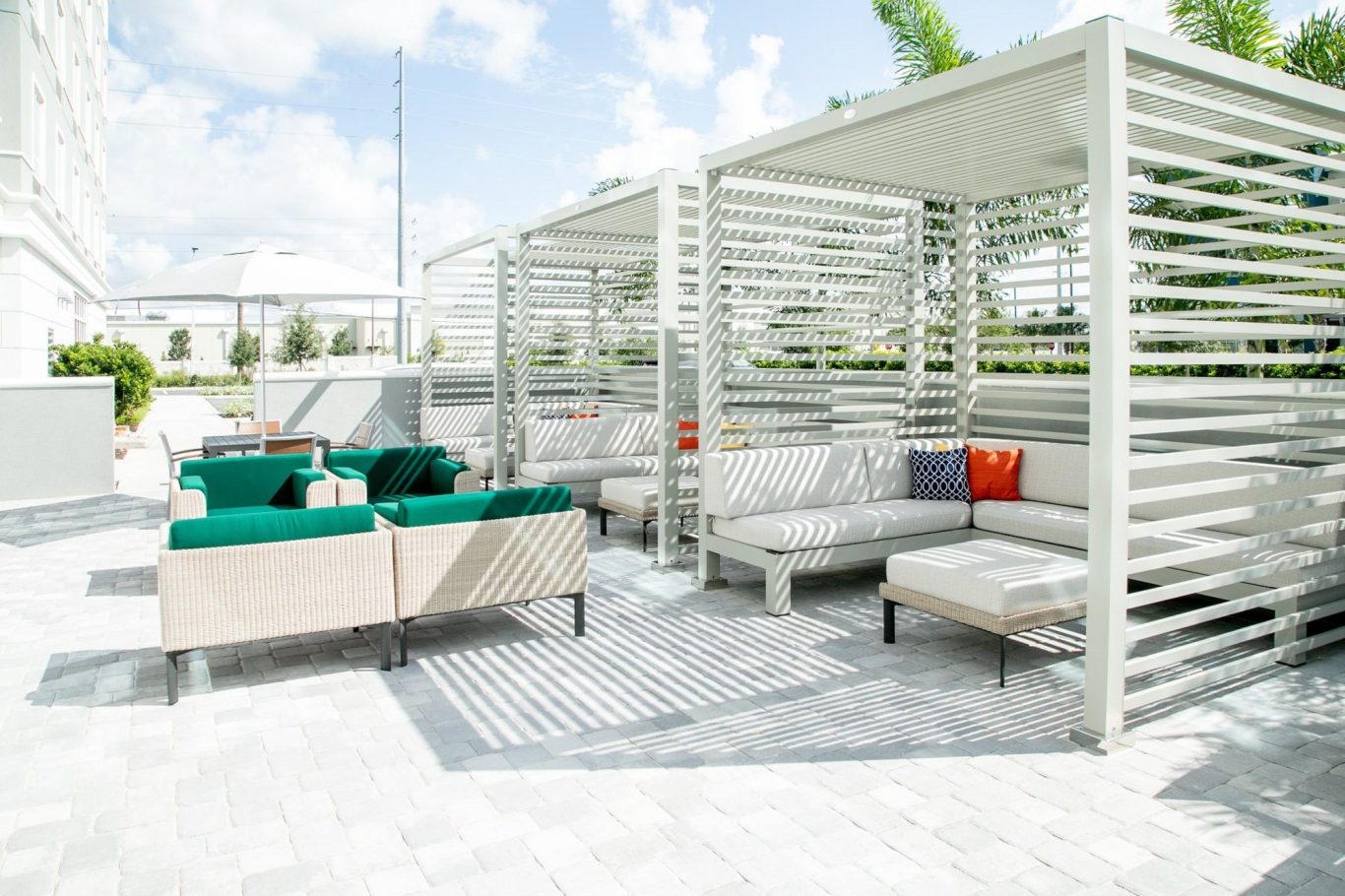 Stylish outdoor lounge area with seating and shade structures.