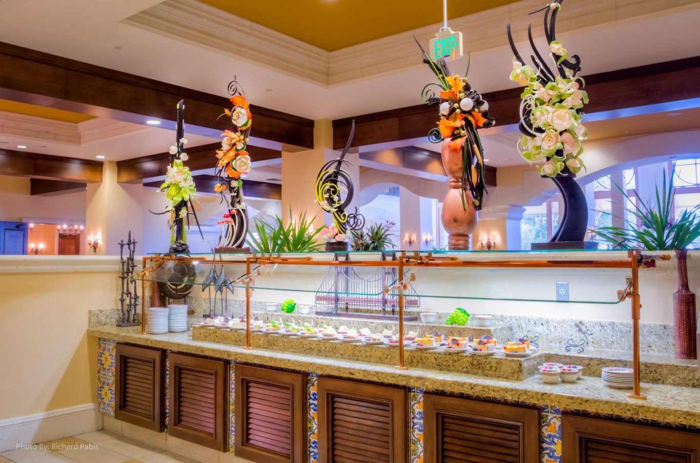 Decorative dessert display with colourful sculptures and a variety of sweets.