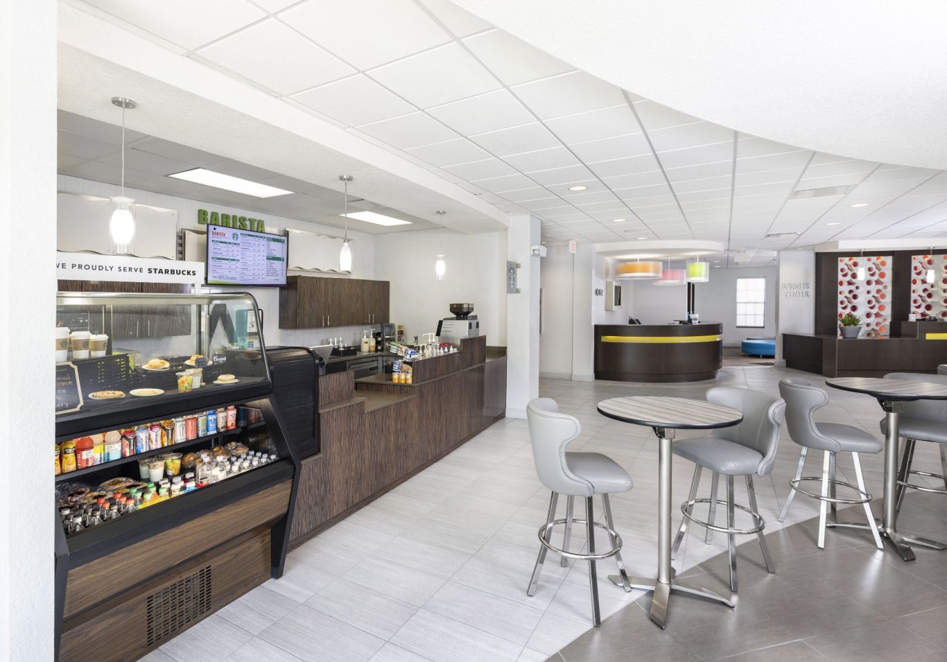 A modern café interior with sleek seating, a service counter, and food displays.