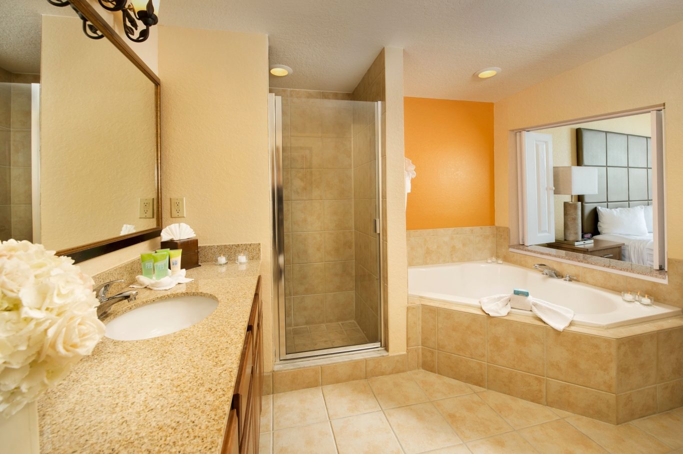 Modern bathroom featuring a shower, bath, and elegant decor with neutral tones.