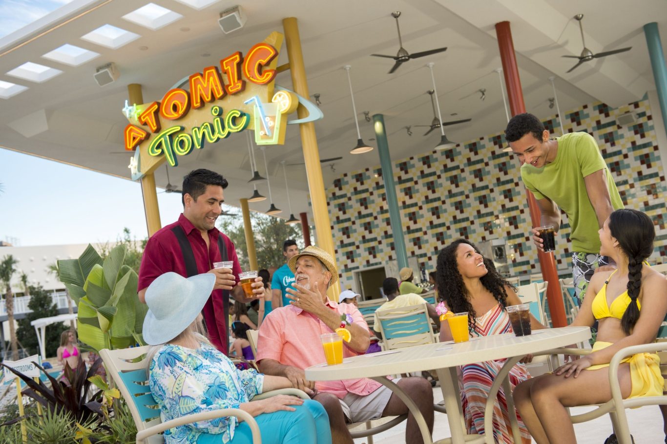 A group of friends enjoying drinks at a colourful outdoor café.