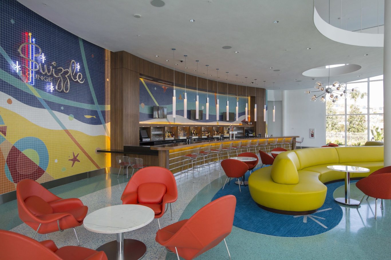 Vibrant lounge area with colourful seating and a modern bar design.