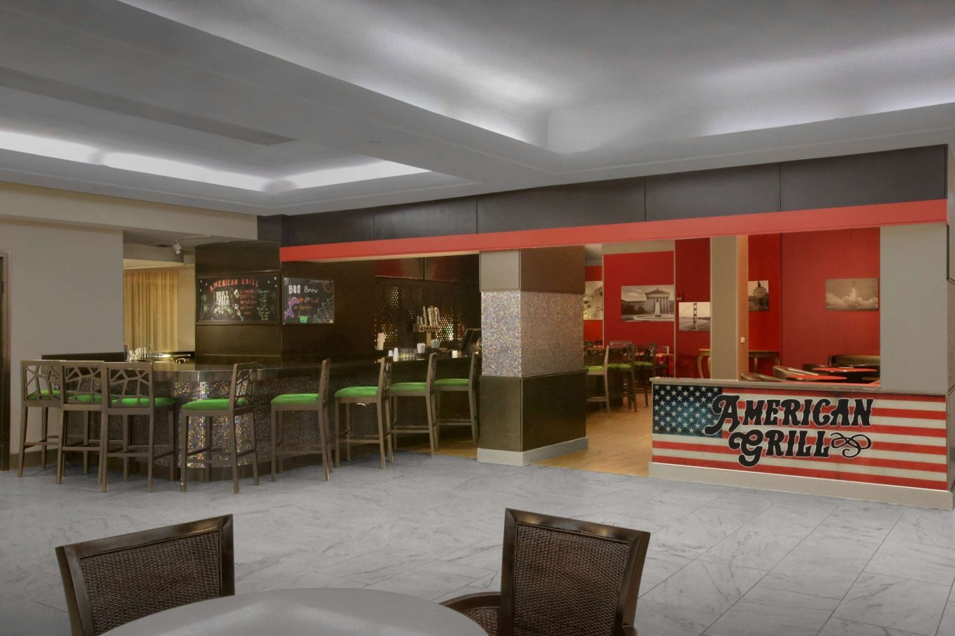 Modern café interior with red and green accents, featuring seating and a prominent counter.
