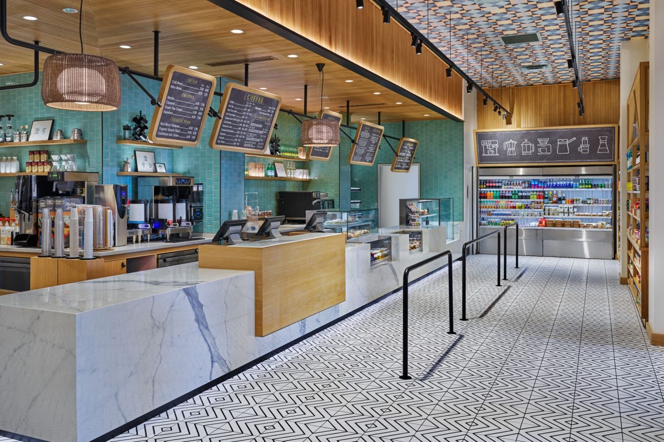 Modern café interior with wooden counters, menu boards, and a tiled floor.