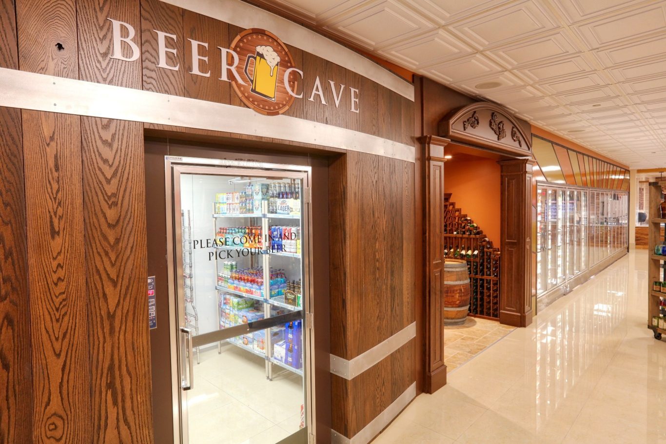 Entrance to a Beer Cafe with wooden decor and glass door displaying beverages.