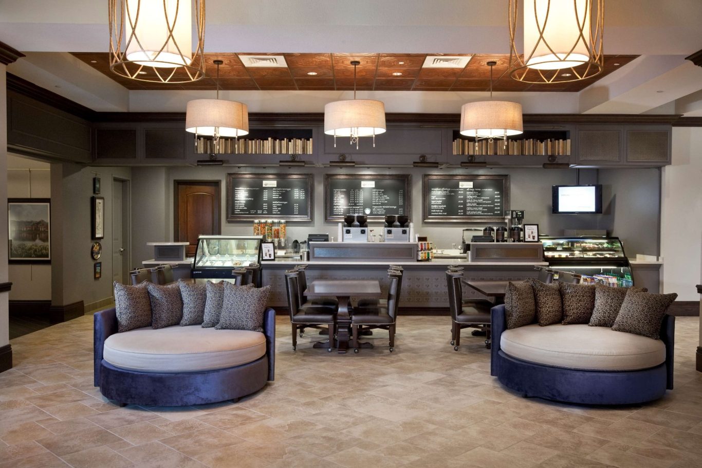 Modern café interior with circular sofas and a stylish counter.