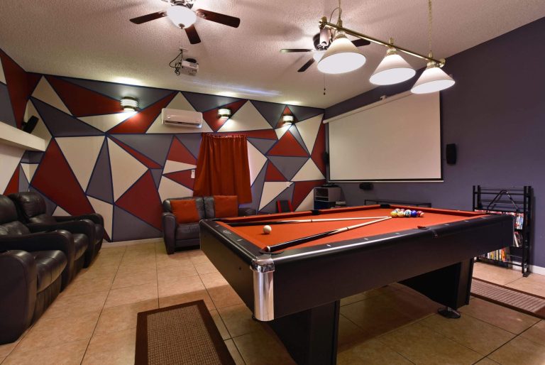 Interior of a game room featuring a pool table and modern wall design.