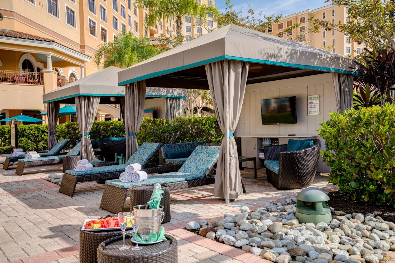 Lounge area with canopies, seating, and a decorative water feature.
