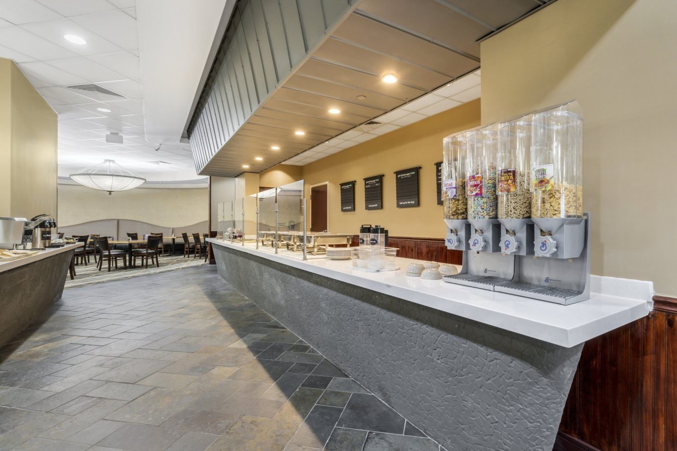 Modern buffet area with a sleek counter and beverage dispensers on display.
