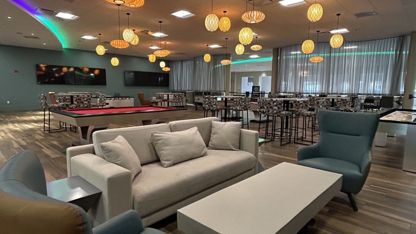 Modern lounge area with sofas, tables, and ambient lighting.